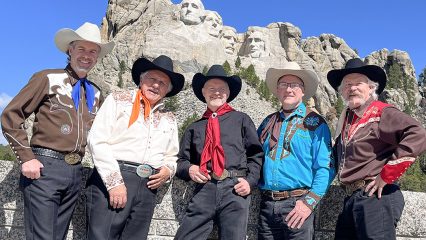 The Sons of the Pioneers posing in front of Mount Rushmore