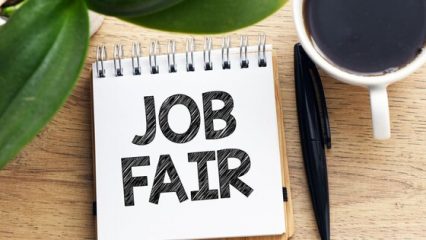 "Job Fair" on a desk notepad