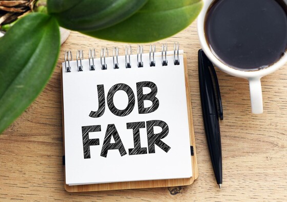 "Job Fair" on a desk notepad