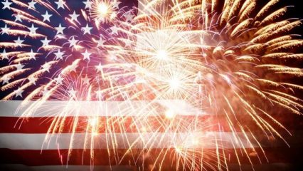 Fireworks in front of an American flag