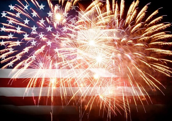 Fireworks in front of an American flag