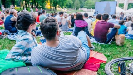 People in a park watching a movie