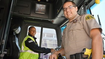 A deputy and a bus driver on a bus