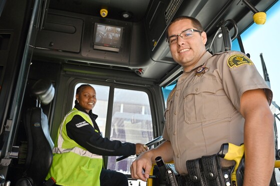 A deputy and a bus driver on a bus