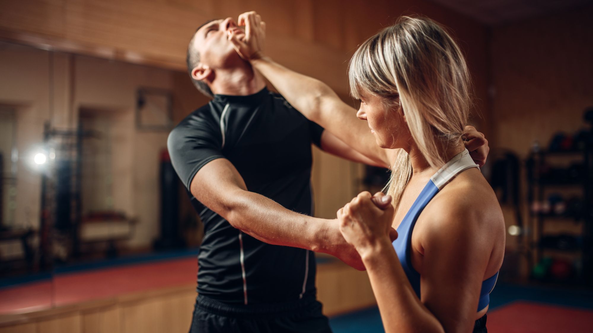 Photo of woman punching man for Lady Be Aware training.