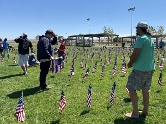 People placing American flags on graves