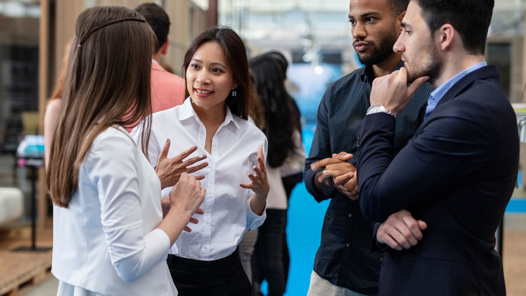 Photo of two women and two men chatting