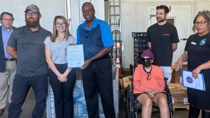 Photo of Kimberly Mesen presenting certificate to High Desert Second Chance staff.