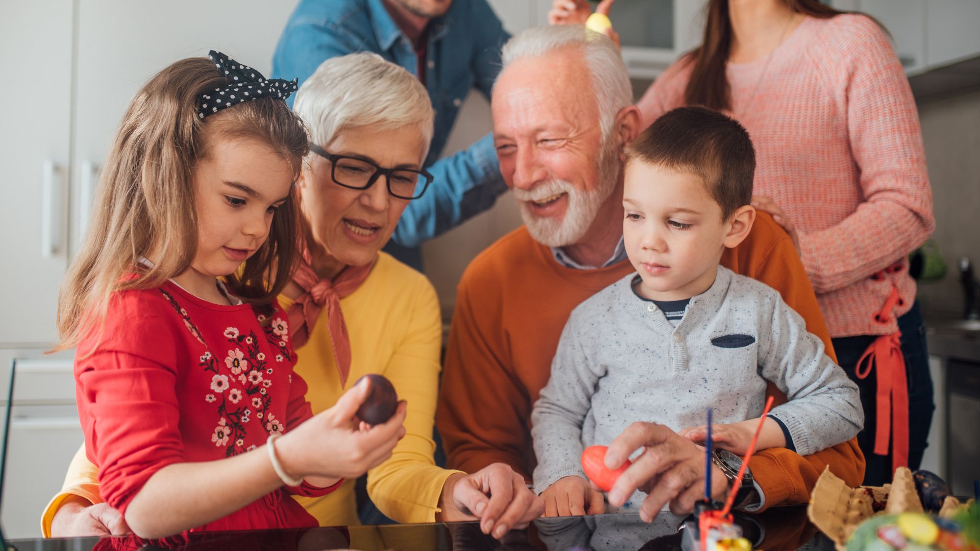 Photo of grandparents with grandkids doing an activity.