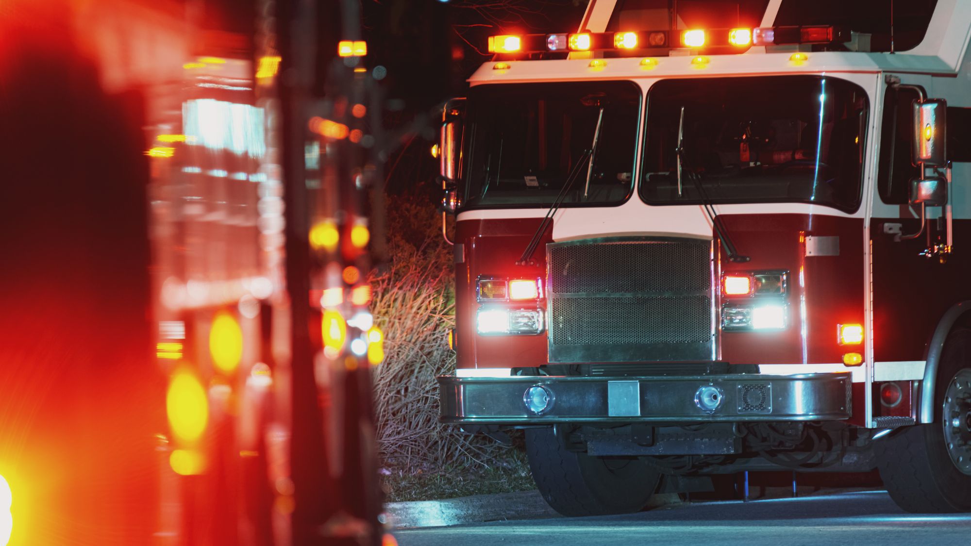 Fire engine with lights flashing at night.