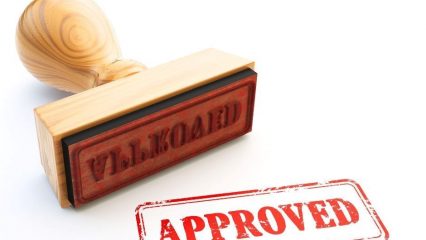 rubber stamp that reads "approved"