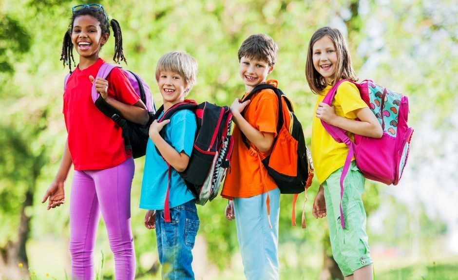 Four kids wearing backpacks