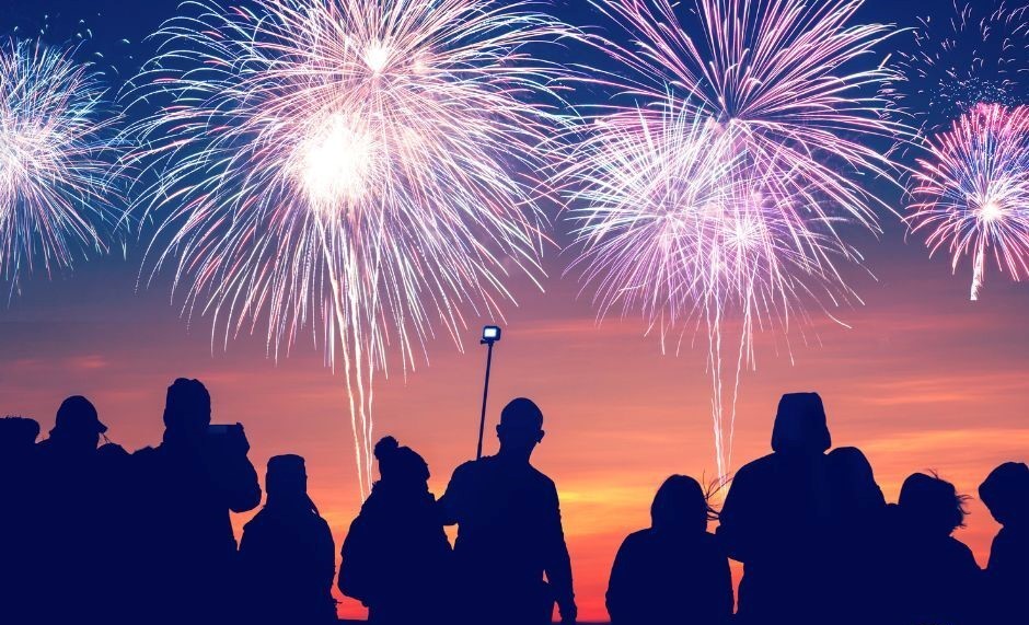 photo of group of people enjoying fireworks display