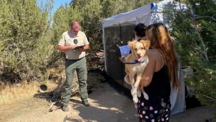 Deputy assisting homeless people in the desert.