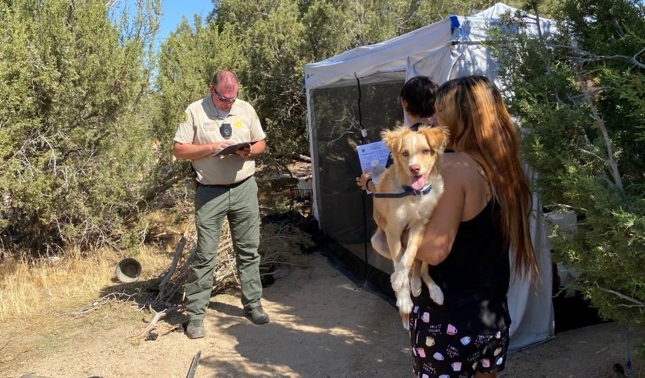 Deputy assisting homeless people in the desert.