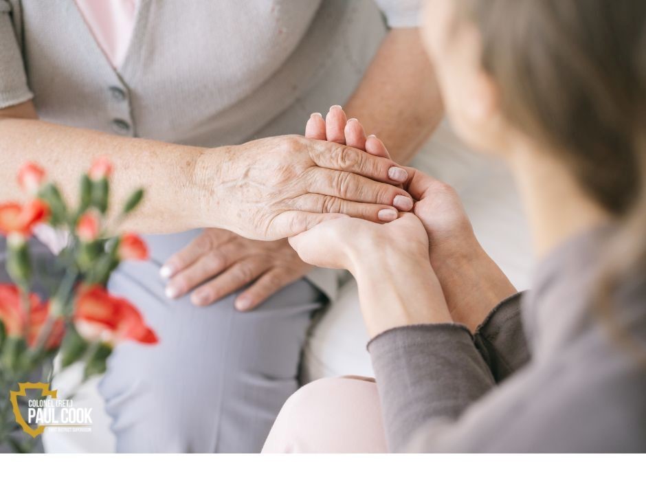 caregiver holding elderly person's hand