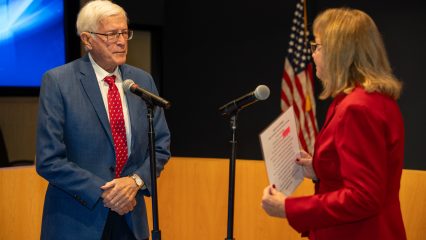 Paul Cook being sworn in by wife Jeanne.