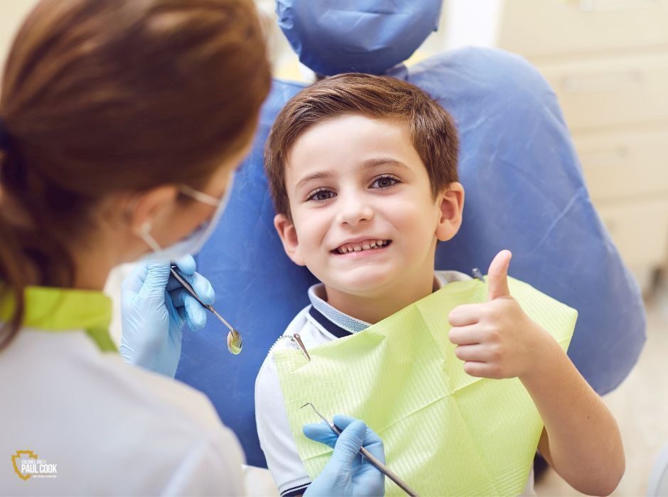 boy at the dentist giving thumbs up