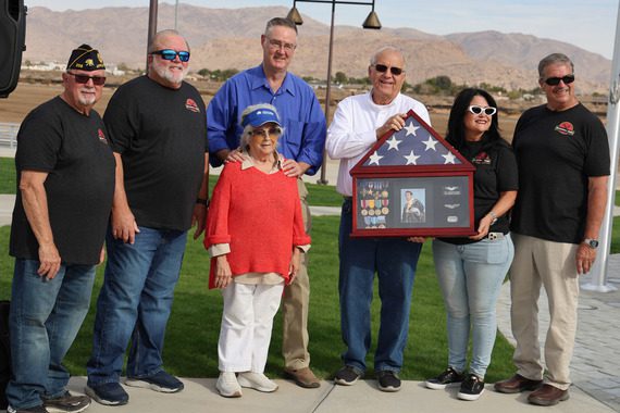 Trish McConnell is presented with a plaque of her father's awards at the Capt. McConnell Veterans Memorial and Park opening.