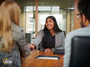 Woman shaking hands during job interview