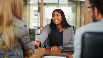 Woman shaking hands during job interview