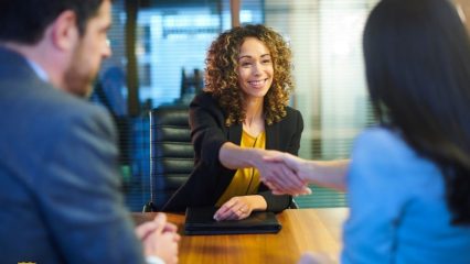 women shaking hands in a business setting