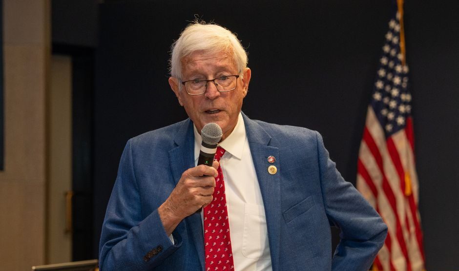 Supervisor Cook speaking with microphone.