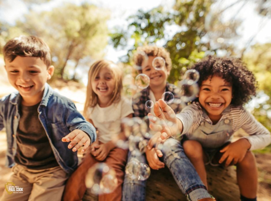 children blowing bubbles