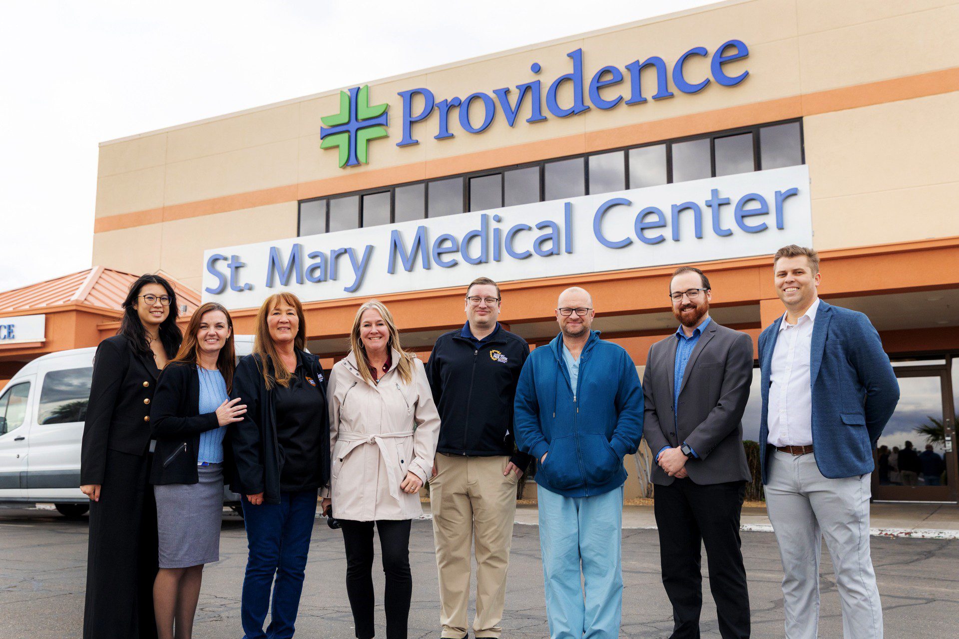 Group photo of Cook's staff and St. Mary staff in front of hospital.